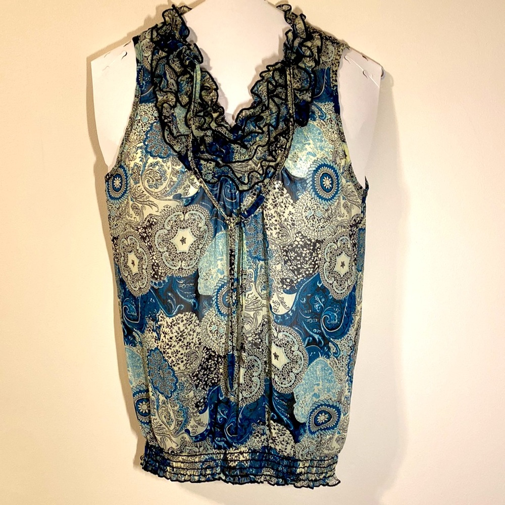 Sleeveless summer top with ruffled neckline